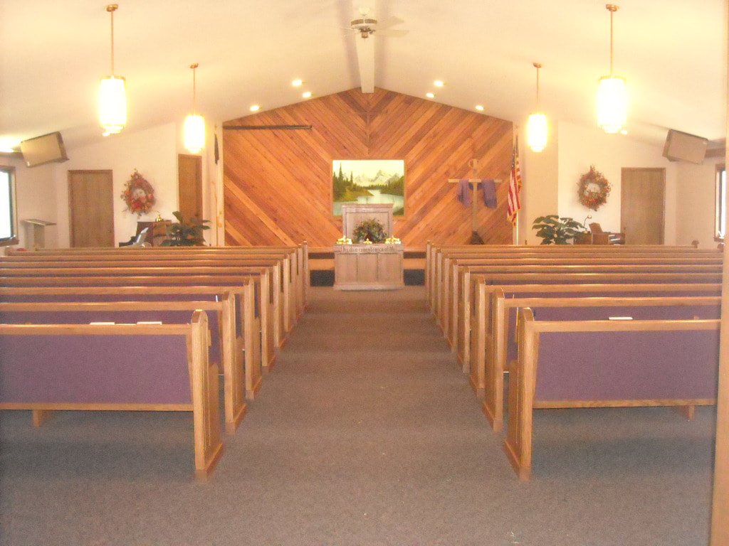 The sanctuary at Countryside Christian Church, pews facing a wood panelled chancel